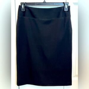 Black pencil skirt lined with size zipper. Size 4.